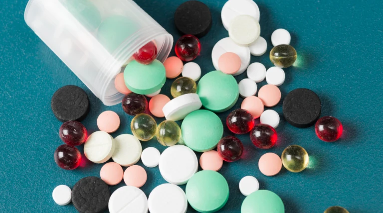 different-pills-plastic-cup.webp