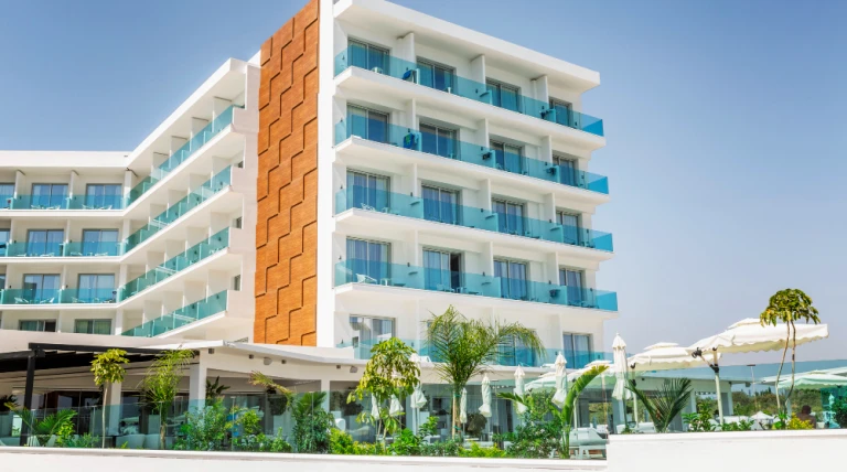 exterior-hotel-resort-with-swimming-pool-sun-loungers.webp