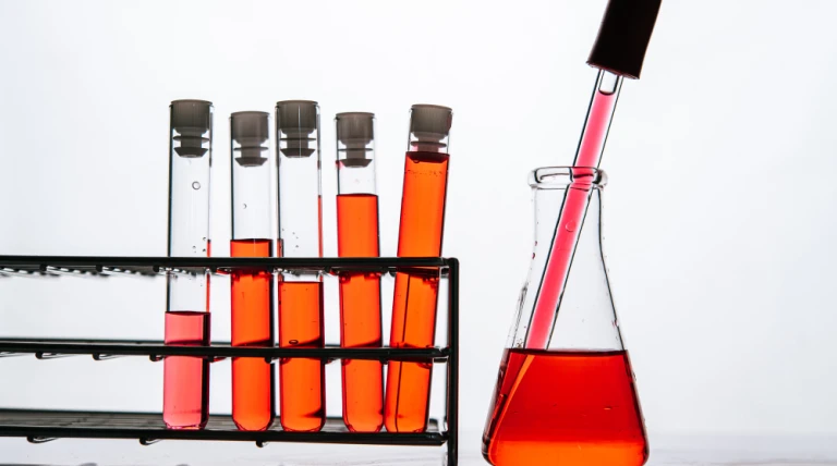 orange-chemicals-science-glass-tube-arranged-shelf.webp