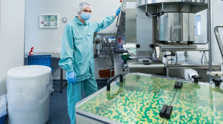 pharmaceutical-industry-man-worker-protective-clothing-operating-production-tablets-sterile-working-conditions.webp